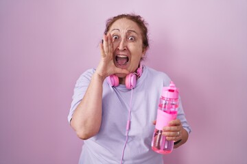 Sticker - Senior woman wearing sportswear and headphones shouting and screaming loud to side with hand on mouth. communication concept.