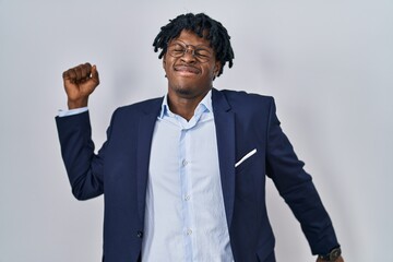 Sticker - Young african man with dreadlocks wearing business jacket over white background stretching back, tired and relaxed, sleepy and yawning for early morning