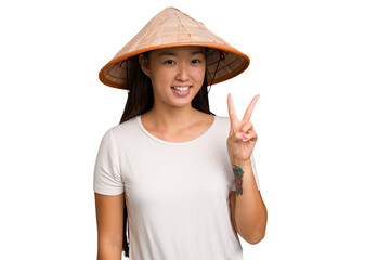 Wall Mural - Young asian woman wearing a Vietnamese hat isolated showing number two with fingers.