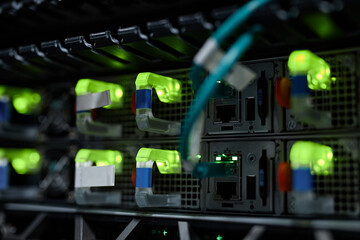 Close up background image of neon indicator lights in server cabinet with internet cables, copy space