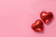 Leinwandbild Motiv Pink background with red hearts balloons