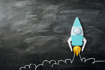 Poster - Front view on blank dark chalkboard background with space for advertising logo or poster and taking off bright graphic rocket, startup concept. 3D rendering, mock up