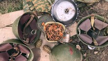 Ukrainian-Russian War. Things Left After Russian Soldiers On Ukrainian Soil. Helmets, Grenades, Cartridges 2022