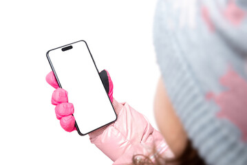 Fototapete - Phone in a gloved hand of a girl, child. Isolated background for app promotion. View over the shoulder