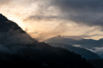 Wall Mural - Cloud forest sunrise with Andes mountains in background, Mindo Tandayapa cloud forest, Quito region, Ecuador.