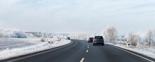 Scenic View Clean Intercity Highway Road Drive Cars With Beautiful White Covered Snow Trees Blue Sky On Background At Bright Cold Sunny Day. Urban Cold Snowy Day Snowstrom Town Background