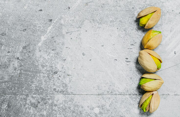 Pistachios on rustic background.