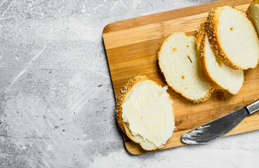 Poster - Breakfast. Fresh bread and butter on a wooden Board.