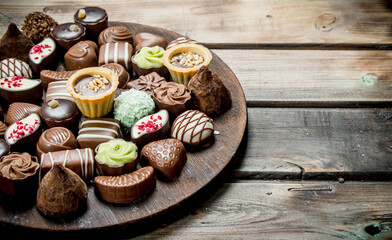 Sticker - Chocolate sweets on a wooden Board.