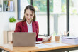 © ArLawKa - Asian businesswoman working with laptop computer and calculator financial documents on table make a plan analyzing financial reports business plan investment in the office