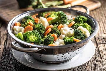 Wall Mural - Steamed broccoli, carrots and cauliflower in a stainless steel steamer. Healthy vegetable concept