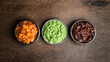 Set of indian chutneys in bowls on wooden background, top view
