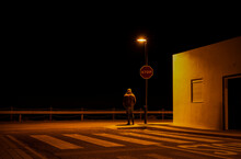 Adult Man Standing On Road Junction With Stop Sign At Night. Cabo De Gata, Almeria, Spain