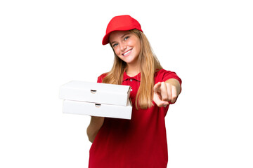 Wall Mural - Young caucasian pizza delivery woman with work uniform picking up pizza boxes over isolated background pointing front with happy expression