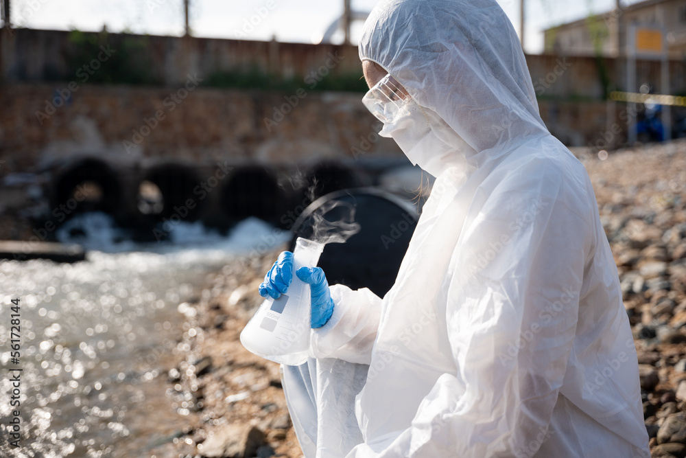 Ecologist sampling water toxic chemicals from river with test tube ...