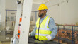 © tampatra - Portrait of black man worker working in large warehouse retail store industry factory. Rack of stock storage. Cargo in ecommerce and logistic concept. Depot. People lifestyle. Shipment service.