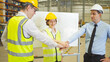 © tampatra - Teamwork of workers working in large warehouse retail store industry.Rack of stock storage. Interior of cargo in ecommerce and logistic concept. Depot. People lifestyle. Shipment service for container