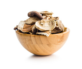 Poster - Various sliced dried mushrooms in bowl isolated on white background.