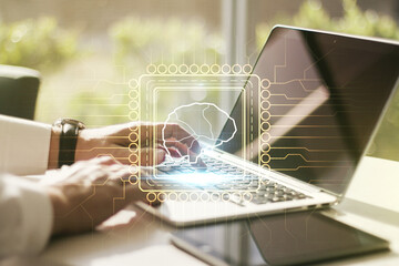 Poster - Creative artificial Intelligence concept with human brain hologram and hands typing on laptop on background. Multiexposure