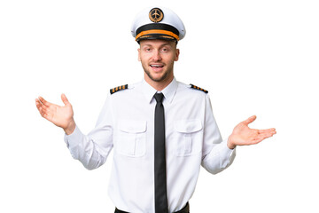 Wall Mural - Airplane pilot man over isolated background with shocked facial expression