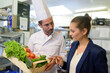 © auremar - manager inspecting crate of vegetables chef is holding