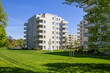 © Westend61 - Modern apartment buildings and garden in residential area
