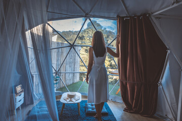 Wall Mural - Travel woman relax inside a luxury camping dome tent