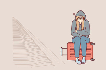 Wall Mural - Tired woman sits on suitcase near railway waiting for train and is sad because of lack of money for ticket. Unhappy girl in hood missed train freezes at station alone. Flat vector illustration