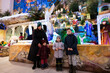 © AS Photo Family - Mother with three children visit Christmas nativity crib scene in church.