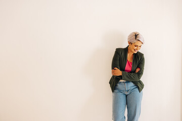 Wall Mural - Successful businesswoman smiling happily against an office wall