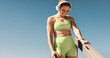© Jacob Lund - Smiling fit woman in sportswear, earphones in and enjoying the sunny day while exercising fitness outdoors