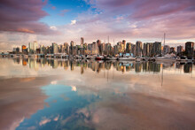 View Of Vancouver Canada British Columbia City Skyline From Stanley Park In The Evening