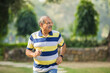 © Niks Ads - Indian old man running or jogging at park
