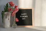 Fototapeta Kwiaty - Vase with tulips and letter board with text Happy Women's Day