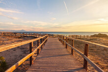 Walkway With Two Paths At Sunrise On The Beach