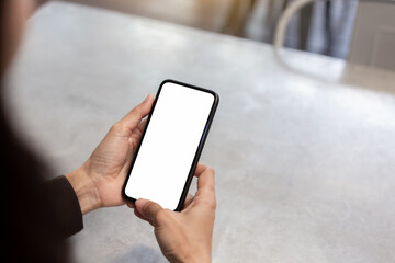 cell phone blank white screen mockup.hand holding texting using mobile on desk at office.background empty space for advertise.work people contact marketing business,technology