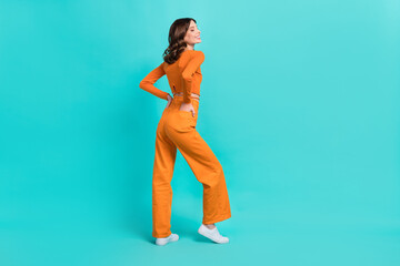 Wall Mural - Full length profile side photo of pretty positive lady dressed fashionable clothes empty space isolated on cyan color background