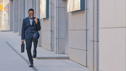 Happy success African American man candidate hired has job offer ethnic worker manager intern businessman winner outdoors feel excited yes gesture celebrating professional triumph victory opportunity