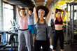 © NDABCREATIVITY - Group of young fit people, friends doing exercises in gym to stay healthy. Sport, people concept.