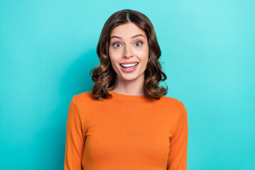 Wall Mural - Photo portrait of pretty young woman excited happy impressed good news wear trendy orange garment isolated on cyan color background