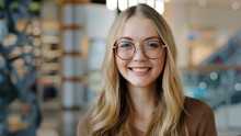 Head Shot Happy Portrait Caucasian Girl In Glasses Young Woman Satisfied With Ophthalmology Services Millennial Blonde With Healthy White Toothy Smile Looking At Camera Confident Model Posing Indoors