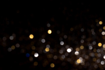 Wall Mural - golden and silver blurred bokeh lights on black background. glitter sparkle stars for celebrate. ove