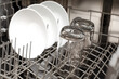© Studiomiracle - Clean dishes are in the dishwasher. The concept of cleaning dirty dishes and glasses