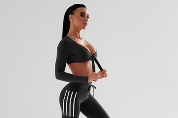 Fitness woman. Athletic girl on the gray background