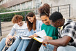 © EFStock - University students sitting on university stairs working and learning together