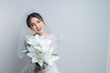 © reewungjunerr - Portrait of asian woman wear bride with flower on white background,Wedding concept