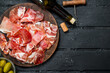 © Artem Shadrin - Spanish ham with red wine and breadsticks.