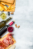 Fototapeta Kuchnia - Antipasto background. Red and white wine with meat and cheese appetizers.