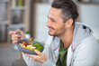 © auremar - a man eating a healthy meal at home