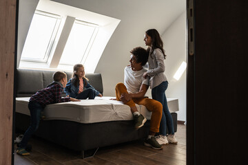 Wall Mural - Mixed race family moving into their new home. They're relaxing and having fun in a still empty apartment.	
